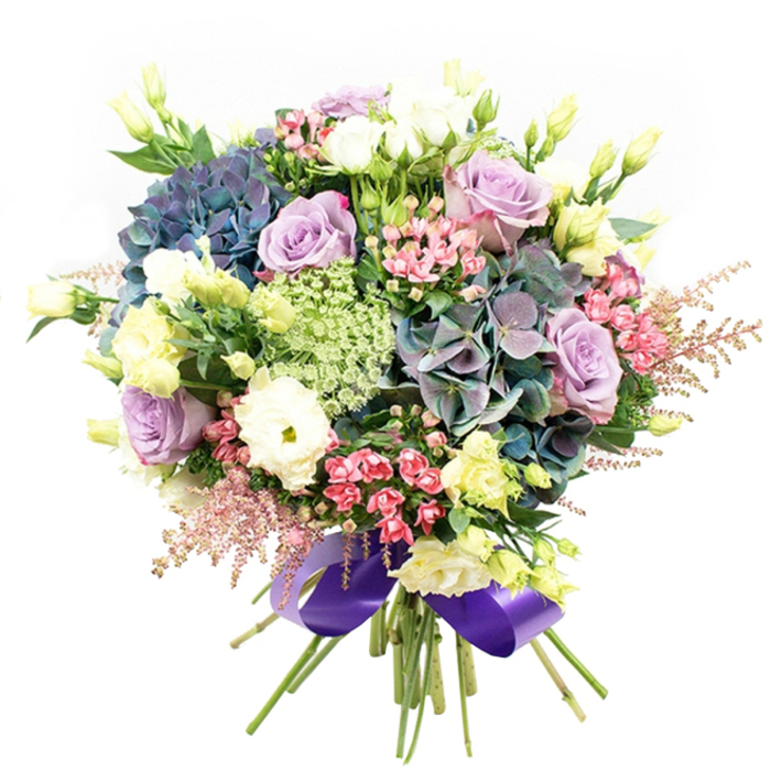 Bursting with harmonious shades and layered botanical textures, this lush bouquet showcases the fresh artistry of Colliers Wood's expert florists. The arrangement centres on impressive hydrangea blooms of indigo and teal, their layered petals creating cool, cloud-like volume, much like those seen near Abbey Recreation Ground in summer. Sweeping around the hydrangeas are opulent roses in soft lilac and creamy white, their petals gently unfolding with a romantic, welcoming grace. Creamy ranunculus offer soft, plush contrast among the heartier blooms, complemented by tall, pale yellow-green lisianthus buds and opening blooms that bring lift and brightness. Sprays of vivid fuchsia filler flowers wind through the arrangement, paired with diaphanous pink astilbe plumes that add movement and intricate fringe. Lacy white and green filler, suggestive of Queen Anne's Lace, lends fine textural highlights, reminiscent of wildflowers along Trevelyan Road. Glossy, deep green foliage enfolds each element, amplifying the bouquet's vibrant presence. All stems are gathered neatly at the base, bound with a sumptuous royal purple satin ribbon that shimmers in soft light, seamlessly tying together the cool floral palette. The bouquet's freshness is underscored by subtle scent-a blend of delicate rose and crisp hydrangea-making it ideal for birthdays, romantic gestures, or to grace a dining table for a special dinner on Western Road. Each detail is considered, every flower a testament to Colliers Wood Florist's passion, bringing joy and a local touch to every occasion.